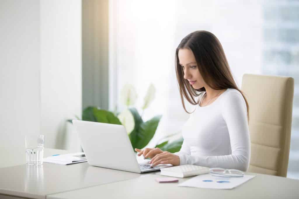 young woman doing an online survey on her laptop