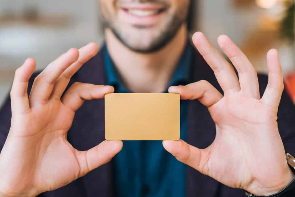 man holding a blank greeting card