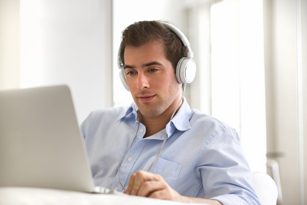 young man transcribing audio