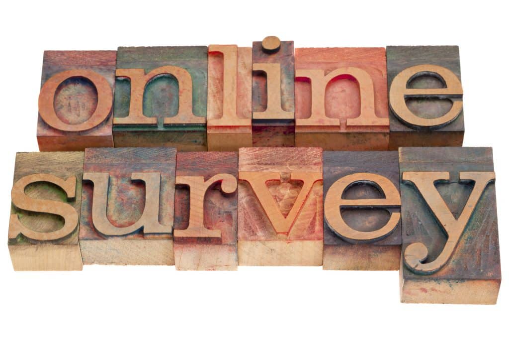 online survey word written in colorful wooden letters