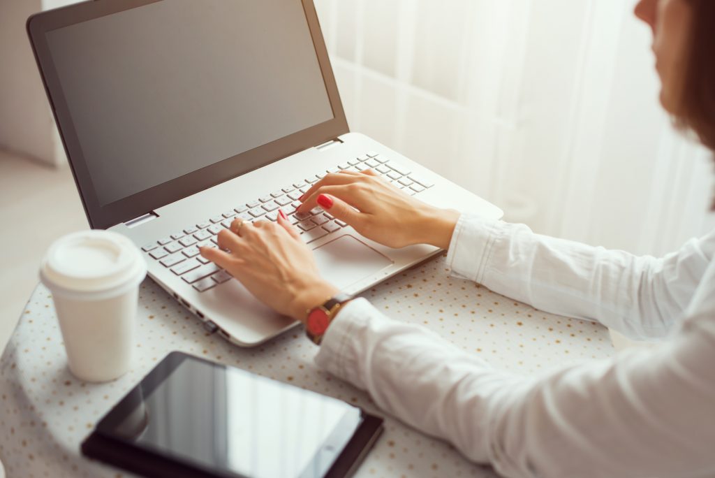 woman doing surveys on her laptop and tablet